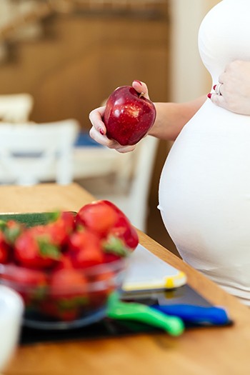 Pregnant Woman with Apple