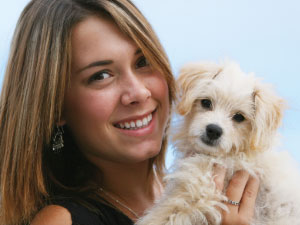 Girl Smiling with a Little Dog