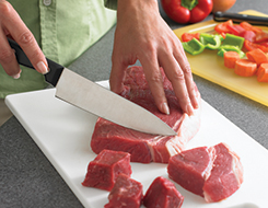 Steak being Sliced on Cutting Board
